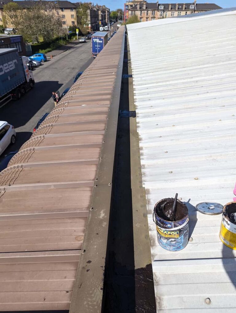 newly sealed gutters with an open tin of roof sealant